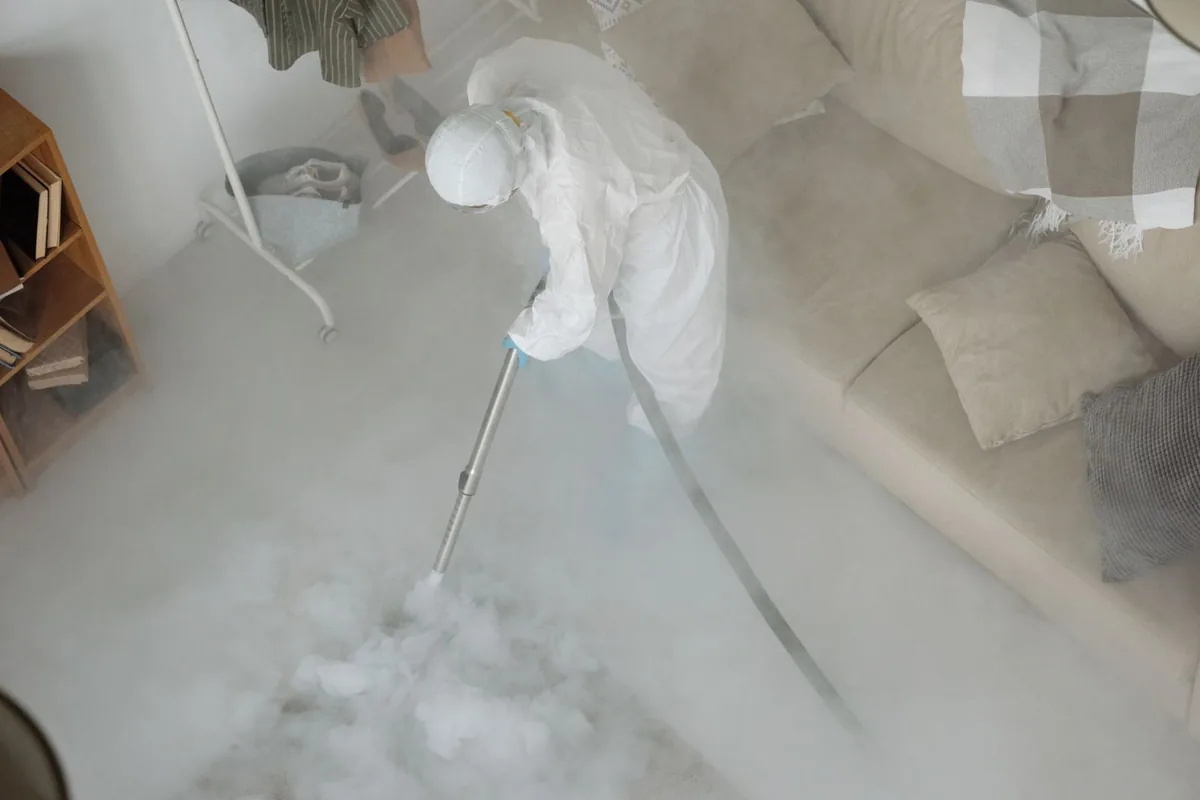 Biohazard cleanup technician in protective equipment, Montgomery City, MO